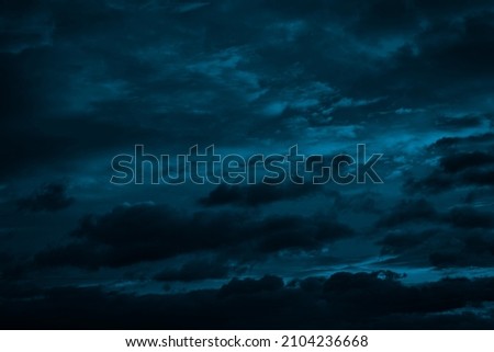  Dramatic sky with clouds. Black blue green night sky. Thunderstorm. Dark teal color background. Ominous,  frightening.                            