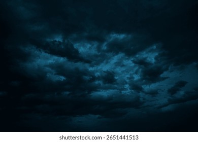 Dramatic sky with clouds. Black dark blue green night sky. Thunderstorm storm. Ominous,  frightening. 