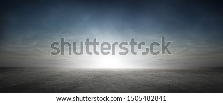 Dramatic Sky with Clouds and Sun Background with Dark Concrete Floor