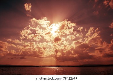 Dramatic sky with clouds and sun beams over ocean