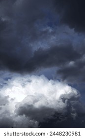 dramatic sky with contrasting cloud formations, ominous storm clouds. concepts: book cover for novels with themes related to storms, suspense or change, weather forecasting websites or apps.