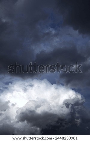 dramatic sky with contrasting cloud formations, ominous storm clouds. concepts: book cover for novels with themes related to storms, suspense or change, weather forecasting websites or apps.