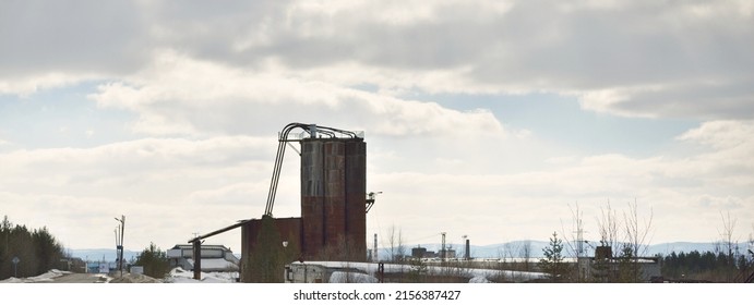 Dramatic Sky With Dark Clouds Above The Old Abandoned Factory. Exterior Close-up. Soviet Architecture, Past, History, Industry, Ecological Issues. Economic Decline In Russia. Winter Cityscape