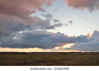 Dramatic Sky, Dark Clouds Above The Plowed Agricultural Field And Forest. Rural Scene. Atmospheric Landscape. Early Autumn. Nature, Fickle Weather, Ecology, Environment, Farm Industry, Remote Places