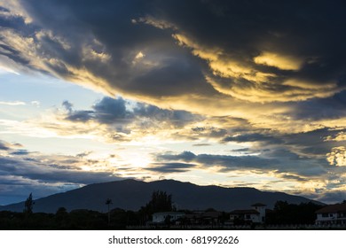 Dramatic sky with dark clouds above the mountain at sunset.