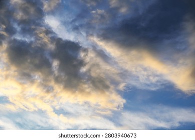 Dramatic sky with dark clouds and golden sunlight breaking through