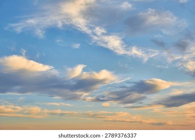 A dramatic sky with dark and light clouds, possibly at sunset or sunrise. A hint of a sun dog or rainbow effect is visible. Weather and nature background.