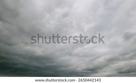 A Dramatic Sky Displaying Gray Clouds Was Beautifully Captured Overhead Above Us