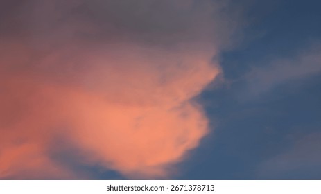 Dramatic sky featuring a contrast of dark blue and vibrant pink clouds, creating a beautiful, atmospheric scene at dusk or dawn.