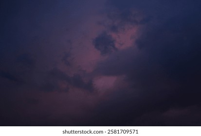 A dramatic sky filled with deep purple and dark blue clouds, creating a mysterious atmosphere during twilight. Soft diffused light peeks through, adding a surreal vibe.