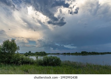 Dramatic Sky Horizon Summer Landscape Rain Clouds Lake Bright Green On The Shore Of The Reservoir, After The Rain. Large Thundercloud.