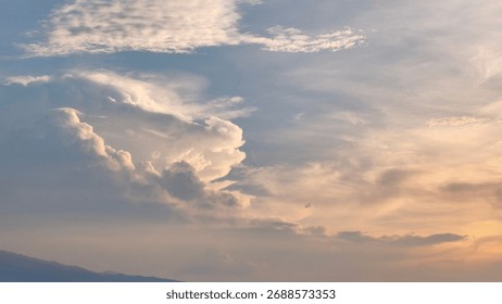 A dramatic sky with large cumulus cloud formations, bathed in soft sunset light. Perfect for a majestic background that conveys hope and the serenity of nature. - Powered by Shutterstock - Get 15% off with code: PIKWIZARD15