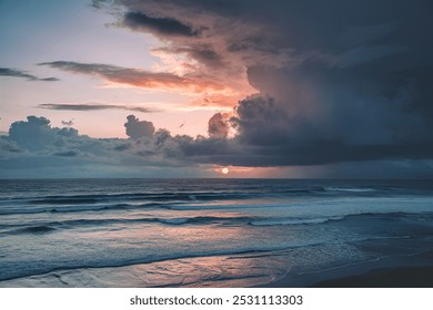 Dramatic sky with low sun behind clouds above the ocean