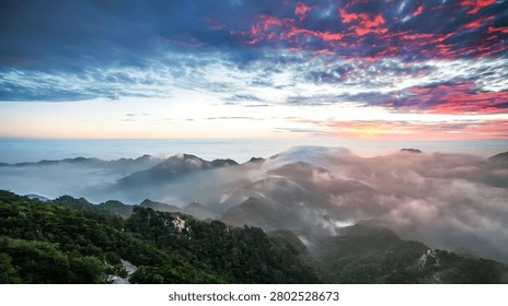 Dramatic sky over a serene mountain vista shrouded in mist. Ideal for travel nature or inspirational campaigns.