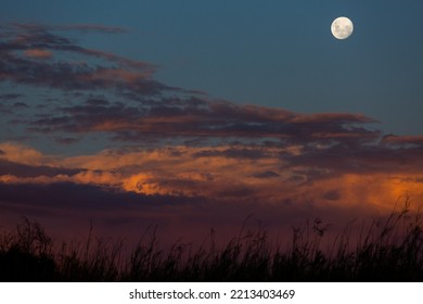 Dramatic Sky Scape With Full Moon And Sunset Clouds