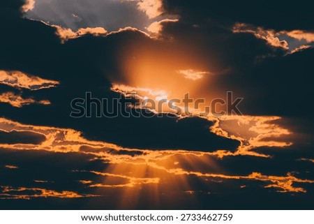 dramatic sky scene dominated by the interplay of sunlight and clouds