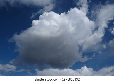 Dramatic Sky With Single Dark Cloud Lit By Sun 