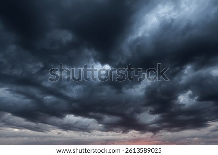 Dramatic sky with storm clouds before rain. Panoramic view of the stormy sky and dark clouds.  Concept on the theme of weather, natural disasters.