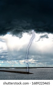 Dramatic sky with stormy clouds. The combination of light and dark clouds. Lightning strikes the ground.