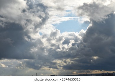 Dramatic sky: stormy, dark clouds meet bright blue and sun's rays. A powerful image for hope and change.