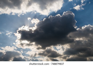 Dramatic sky, sun behind dark clouds