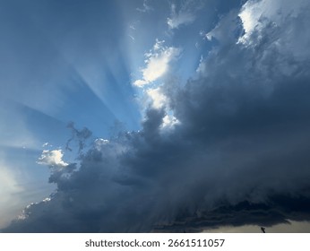 Dramatic Sky with Sun Rays Breaking Through Storm Clouds 