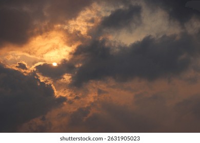 Dramatic sky with sun rays and dark clouds before sunset