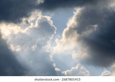 Dramatic sky with sunbeams shining through dark storm clouds. Beautiful natural light phenomenon creating contrast between darkness and hope. Ideal for nature backgrounds, inspirational themes, enviro - Powered by Shutterstock - Get 15% off with code: PIKWIZARD15