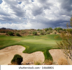 Dramatic Sky With Sunlight Shining On Beautiful Desert Golf Course Green In Scottsdale,AZ