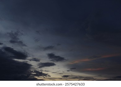 Dramatic sky at sunset, dangerous heavy gray orange color clouds in sky, abstract sky and nature background