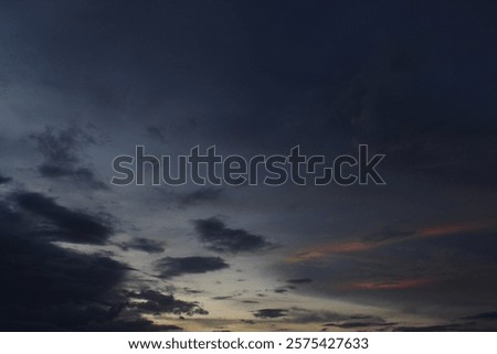 Dramatic sky at sunset, dangerous heavy gray orange color clouds in sky, abstract sky and nature background