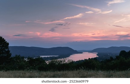 dramatic sky sunset during blue hour overlooking the Danube from a high vantage point, in the Danube knee, looking from Hungary towards Slovakia with Szob in the foreground - Powered by Shutterstock