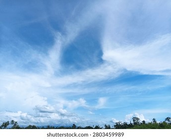 Dramatic sky with thick white clouds and blue patches overhead
