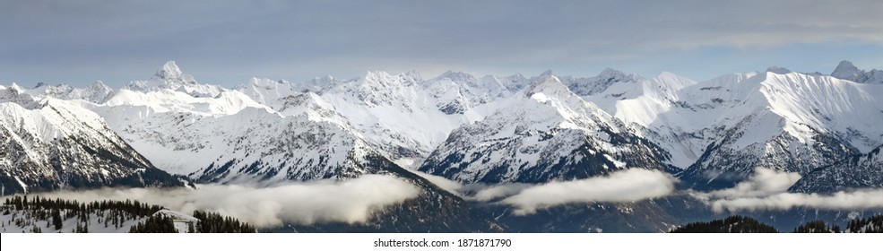 Dramatic Snow Covered Mountains Landscape. Amazing Panoramic Snowy Winter Landscape In Alps At Sunrise Morning. View From Riedberger Horn Grasgehren Ski Resort To Allgau Alps, Bavaria, Germany.