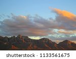 Dramatic, Soft pastel blue and pink sunset monsoon clouds over the Santa catalina mountains in Catalina State Park tucson arizona