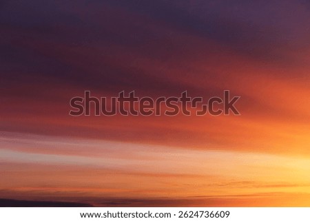 Dramatic soft sunrise, sunset red violet orange sky with clouds and yellow sunlight abstract background texture