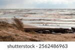 dramatic storm in the Baltic Sea, large waves crashing against the shore, blurred, unclear contours, rocky shore of Vidzeme, Thuja, Latvia