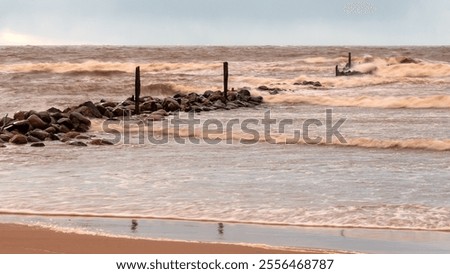 dramatic storm in the Baltic Sea, large waves crashing against the stone pier, blurred, unclear contours, rocky shore of Vidzeme, Thuja, Latvia