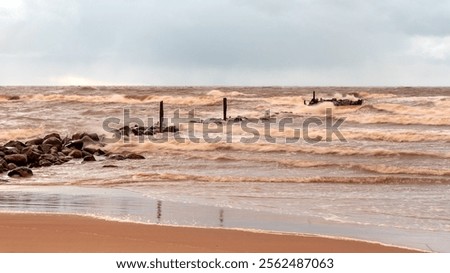 dramatic storm in the Baltic Sea, large waves crashing against the stone pier, blurred, unclear contours, rocky shore of Vidzeme, Thuja, Latvia