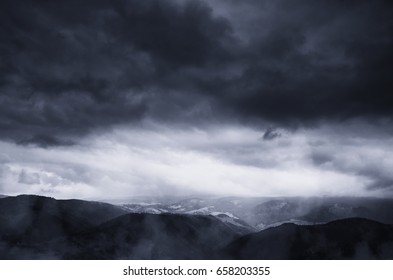 dramatic storm clouds in dark landscape