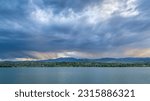 dramatic storm clouds at dusk over Rocky Mountains and lake in northern Colorado