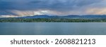 dramatic storm clouds at dusk over Rocky Mountains and lake in northern Colorado