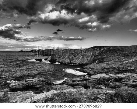 Dramatic storm clouds gathering above a rugged Mediterranean coastline in Greece. Stylised landscape with strong contrast and textured skies, suitable for weather editorial, climate change features, e