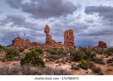 Dramatic Storm Clouds Looming Over The Popular Balanced Rock Sandstone Rock Formation, Arches Scenic Drive, Arches National Park, Moab, Utah