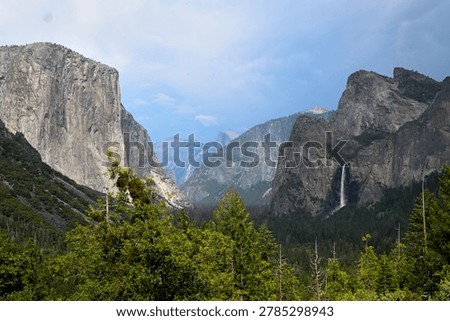 Dramatic storm clouds and a looming thunderstorm build over Yosemite Valley in Yosemite National Park, California. Iconic granite cliffs including El Capitan and Half Dome stand powerful against the darkening sky, capturing the raw majesty and ever-changing weather of one of America’s most beloved national parks. This powerful moment highlights nature’s dramatic forces over the iconic landscape.