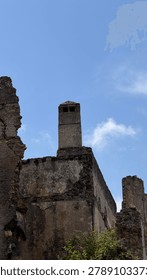 Dramatic storm clouds over an abandoned historic stone village on a hillside. Ancient ruins, rustic architecture, and a mystical Mediterranean landscape create a powerful travel, history, culture, and nature concept image.