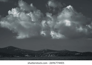 Dramatic storm clouds over coastal landscape