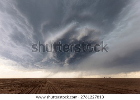 Dramatic storm clouds over a farm field in Colorado