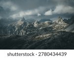 Dramatic Storm Clouds over Rugged Dolomite Mountain Peaks with Alpine Hut, Tre Cime Area Italy