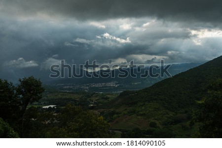 dramatic storm clouds over a small caribbean mountain town of Ocoa, dominican Republic.